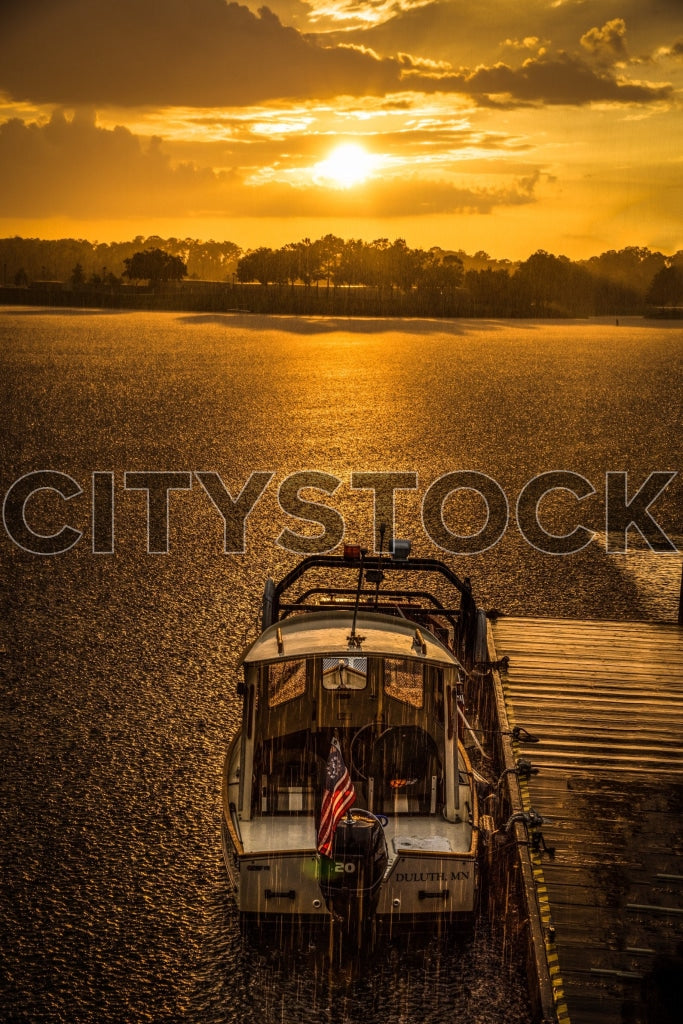 Golden sunset with waterfront view and boat in Charleston, SC