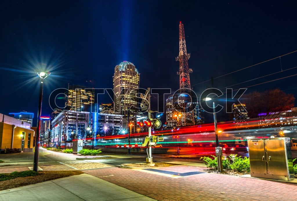 Charlotte downtown skyline at night with glowing lights and traffic