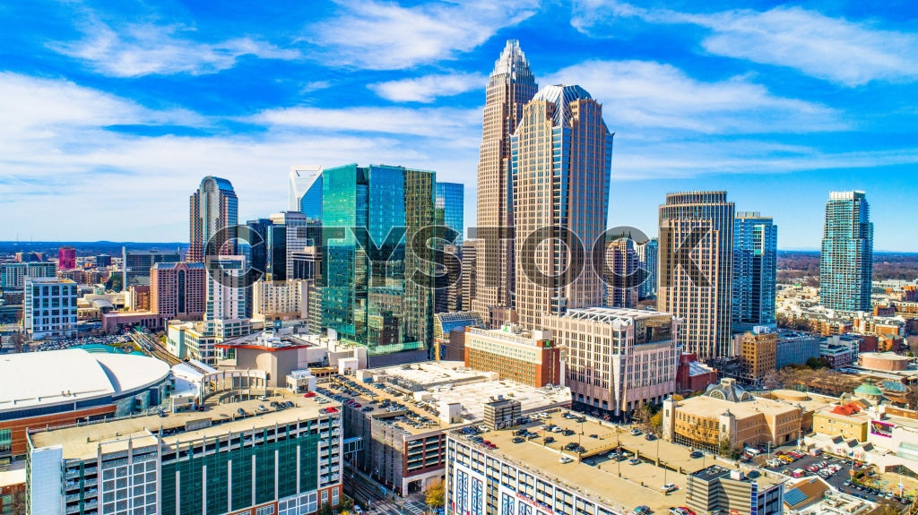 Aerial view of Charlotte, NC showcasing modern skyscrapers and blue skies