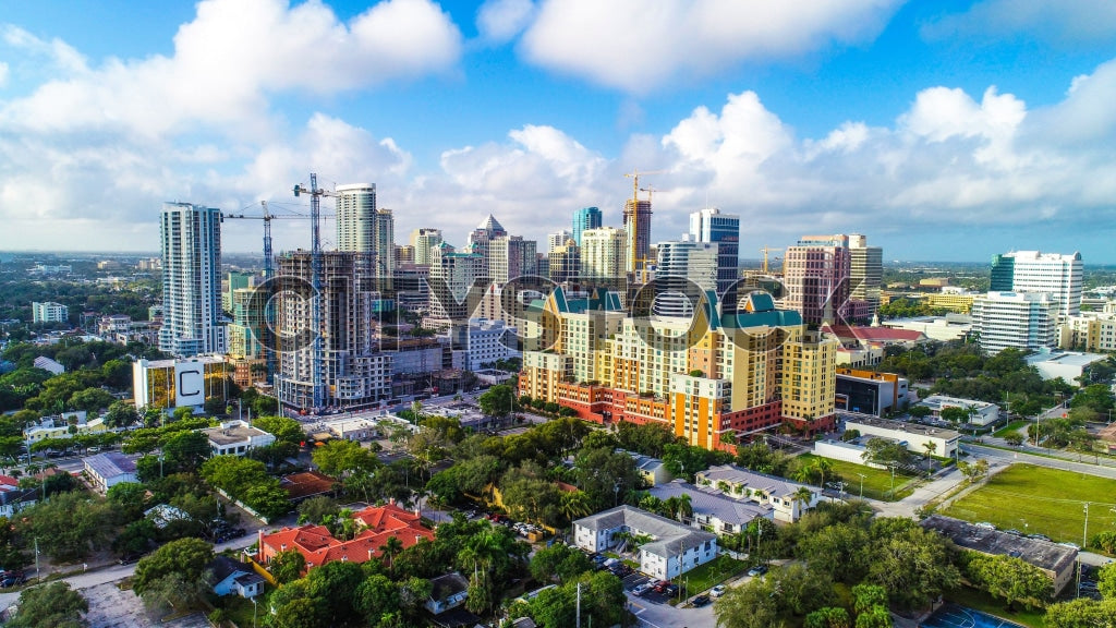 Aerial view of Fort Lauderdale skyline at sunset with lush spaces