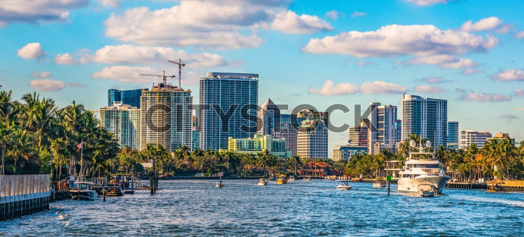 Fort Lauderdale skyline with yachts and palm trees under blue sky
