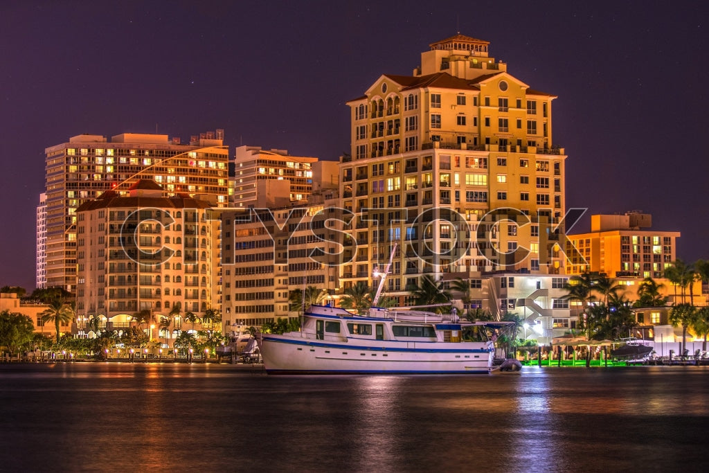 Luxurious yacht at Fort Lauderdale waterfront buildings during twilight