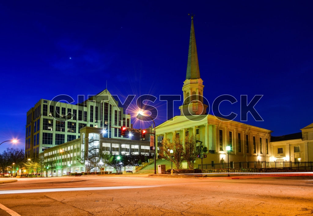 Greenville, SC cityscape at twilight with historic church and modern buildings