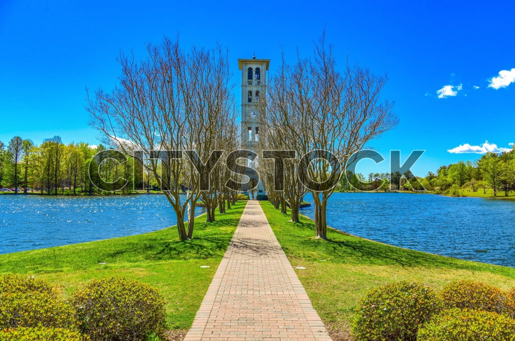 Path leading to a bell tower beside a lake in Greenville