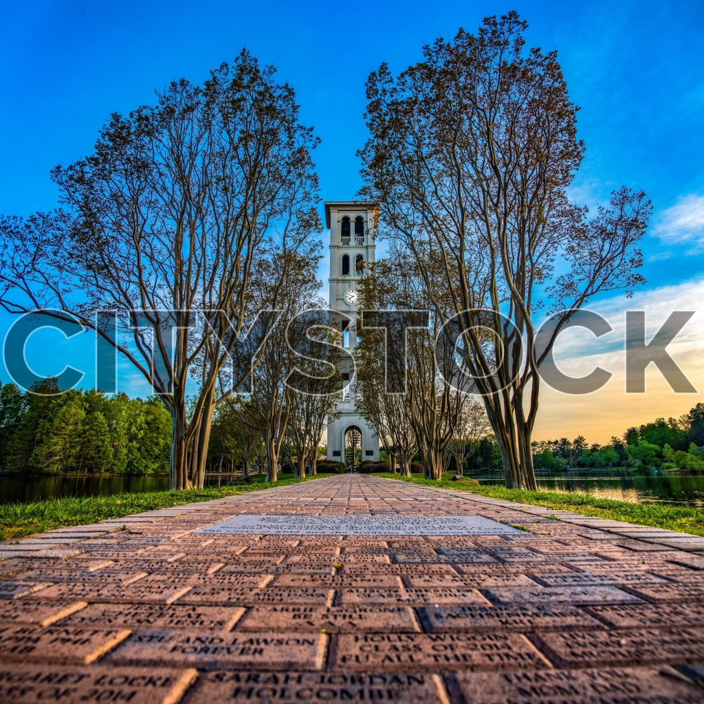 Historic bell tower at sunrise, cobblestone path Greenville SC