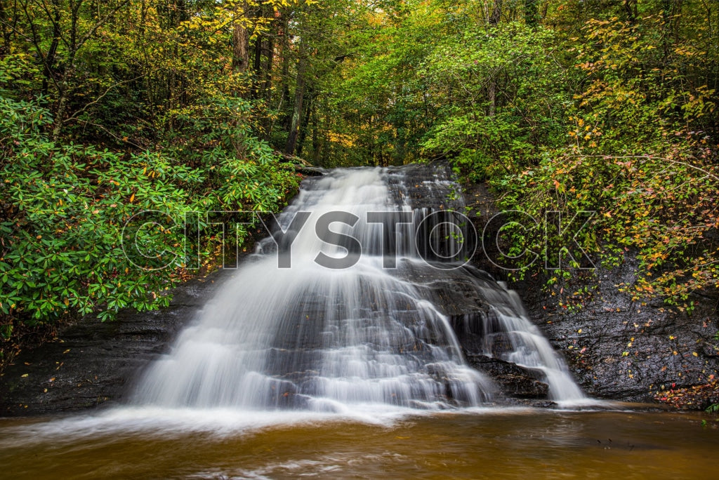 Cascading waterfall with autumn leaves in Greenville, SC