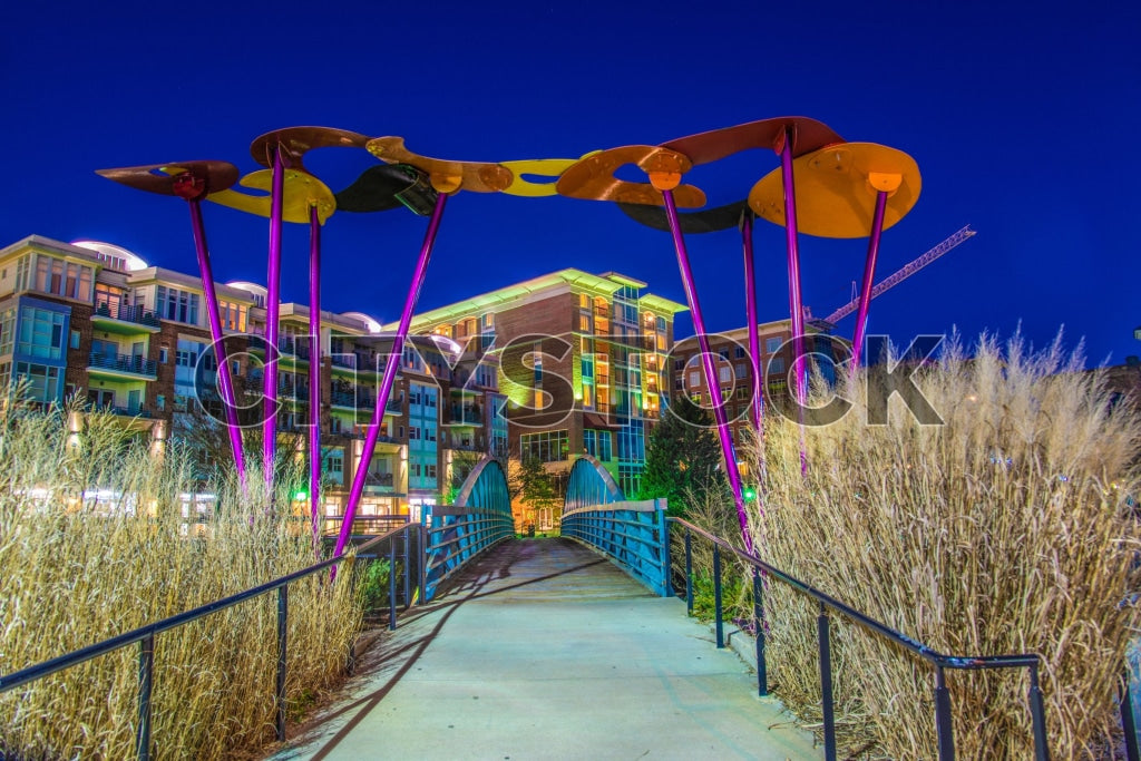 Modern art sculpture at sunset, colorful buildings in Greenville, SC