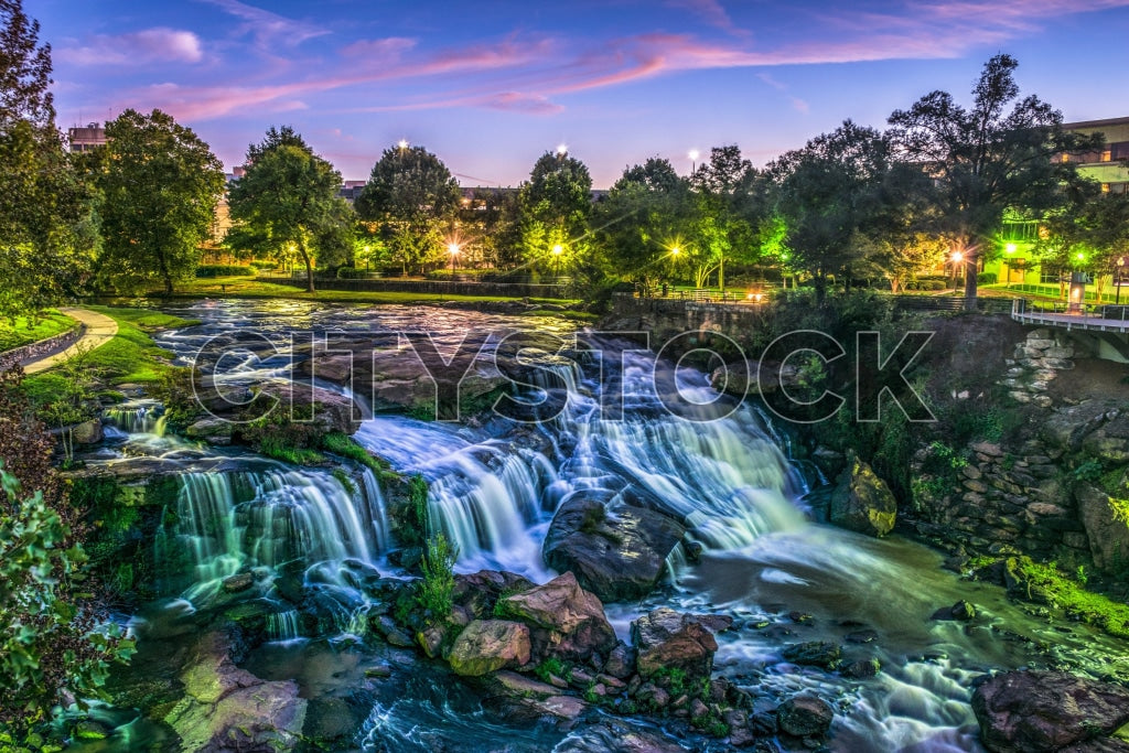 Twilight over Greenville waterfall with city lights