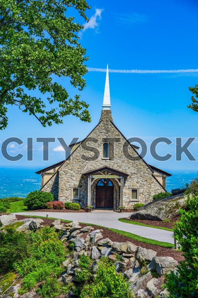 Serene stone chapel with white spire in Greenville, SC