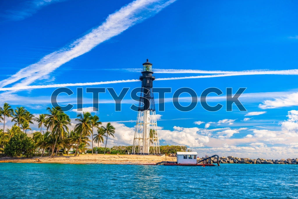 Lighthouse in Hillsboro Beach, Florida with palm trees and ocean