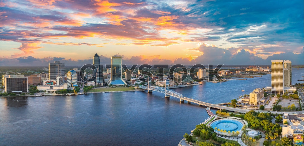 Aerial view of Jacksonville cityscape at sunset with river and bridges