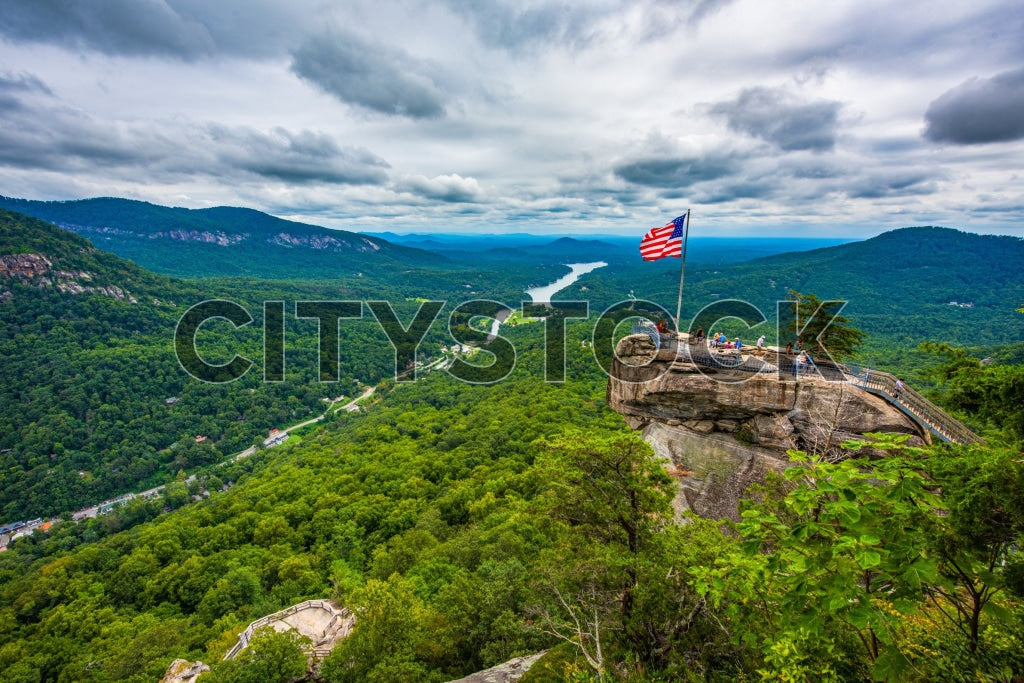 American flag atop Chimney Rock with panoramic view of Lake Lure