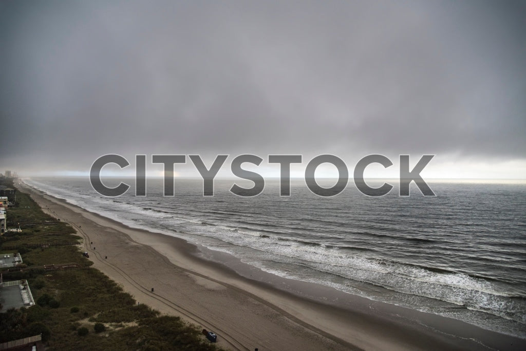 Aerial view of Myrtle Beach coastline under dark storm clouds