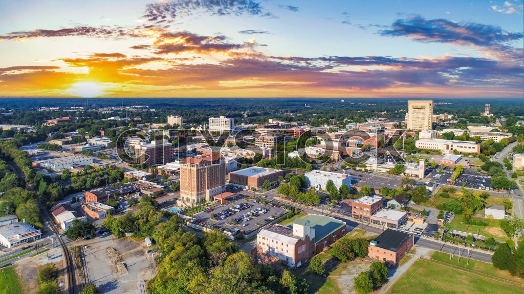 Aerial view of Spartanburg, SC during sunset with golden skies